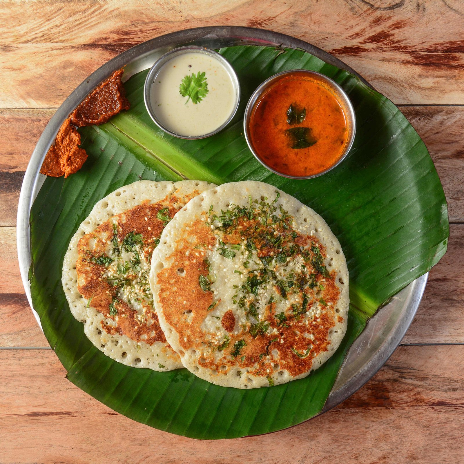 Set Dosa, a south Indian traditional and popular Breakfast served with chutney and sambar over a rustic wooden background, selective focus